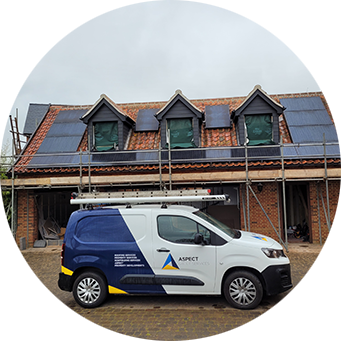 a van parked in front of a house with solar panels on the roof.