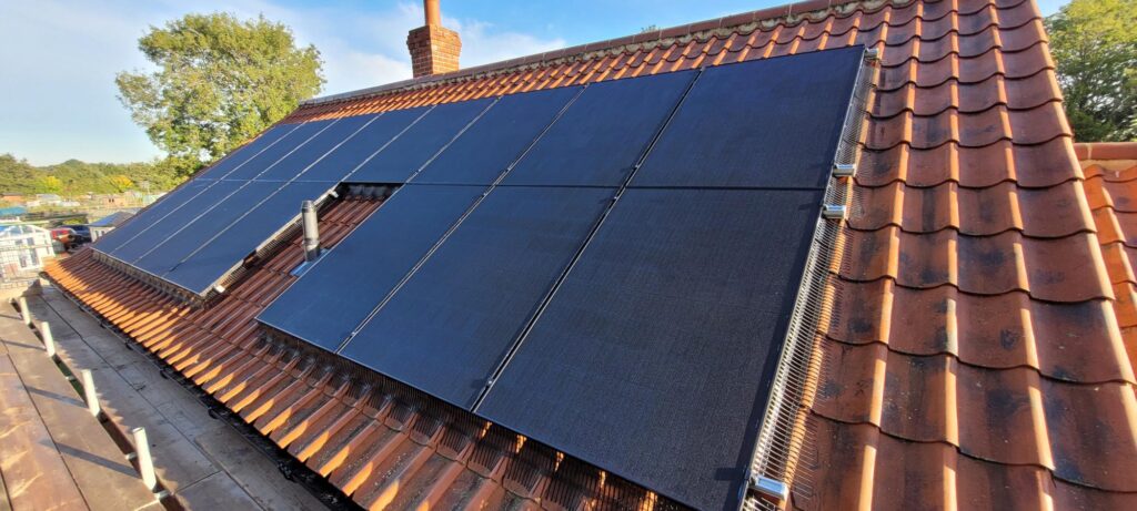 A solar panel on the aspect of a house.