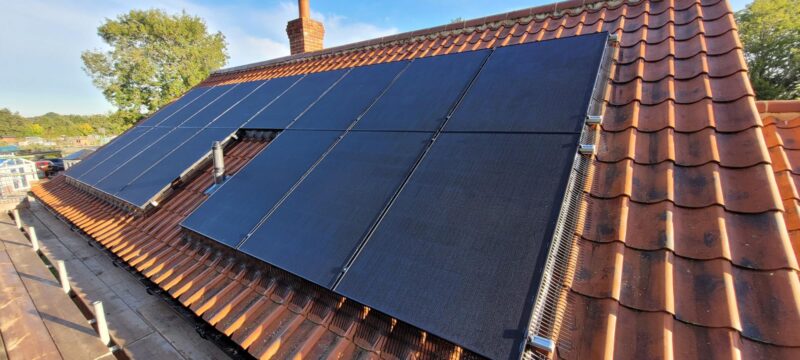 Black solar panels generating clean energy on a rooftop.