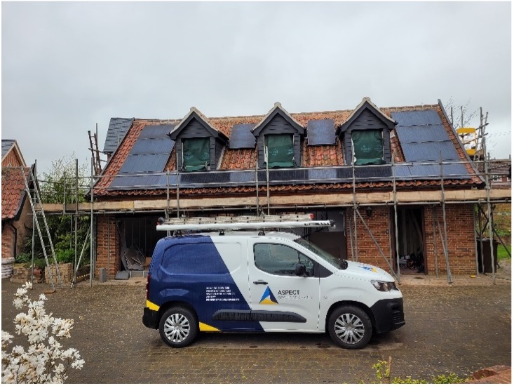 a van parked in front of a house under construction.